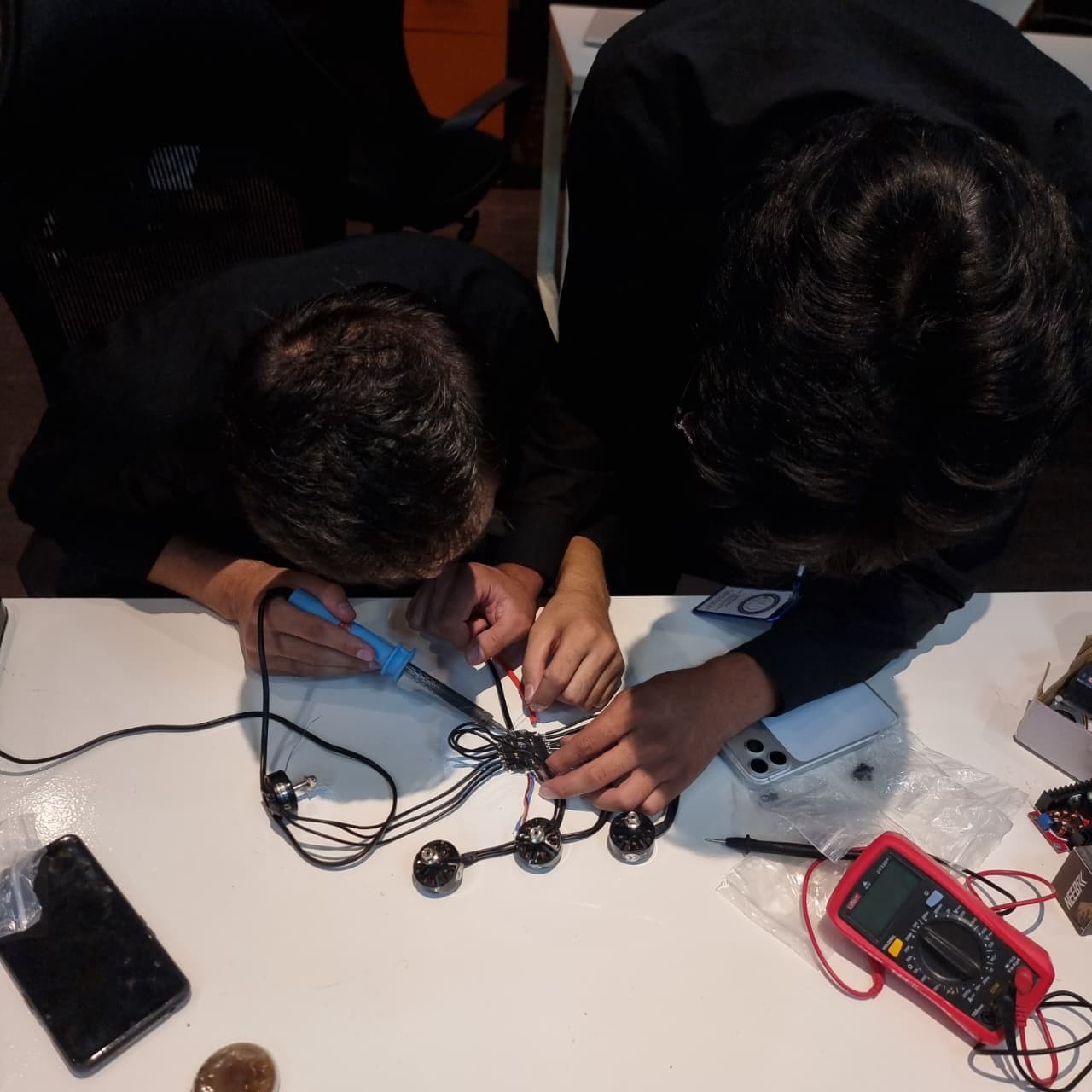 SafeSky Nexus engineers soldering motor connections during assembly